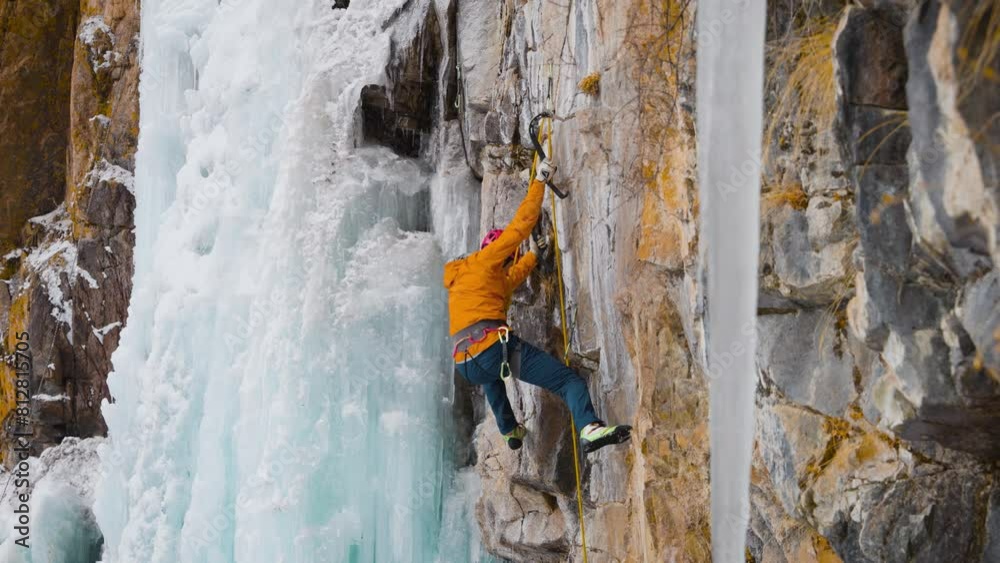Ice climbing at frozen waterfall. Ice climbing at frozen waterfall.