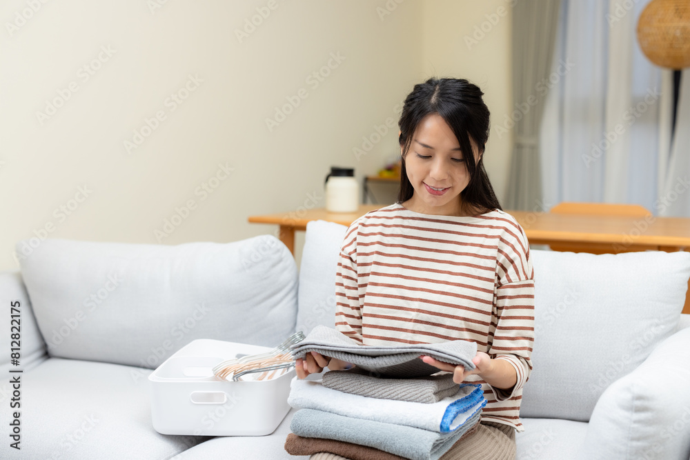 Housewife do housework with fold the towel at home Housewife do housework with fold the towel at home