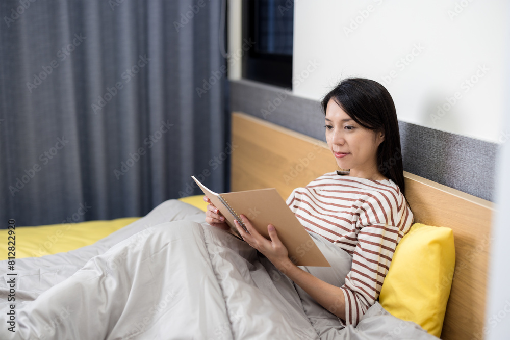 Woman read on notebook on bed at home Woman read on notebook on bed at home