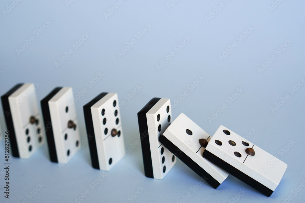 falling dominoes, chain reaction, domino effect or butterfly effect concept falling dominoes, chain reaction, domino effect or butterfly effect concept