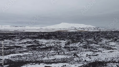 Completely snow-covered Krafla lava fields with areas with water vapor and sulfur geysers. The Leirhnjukur geothermal area in autumn in Iceland. photo