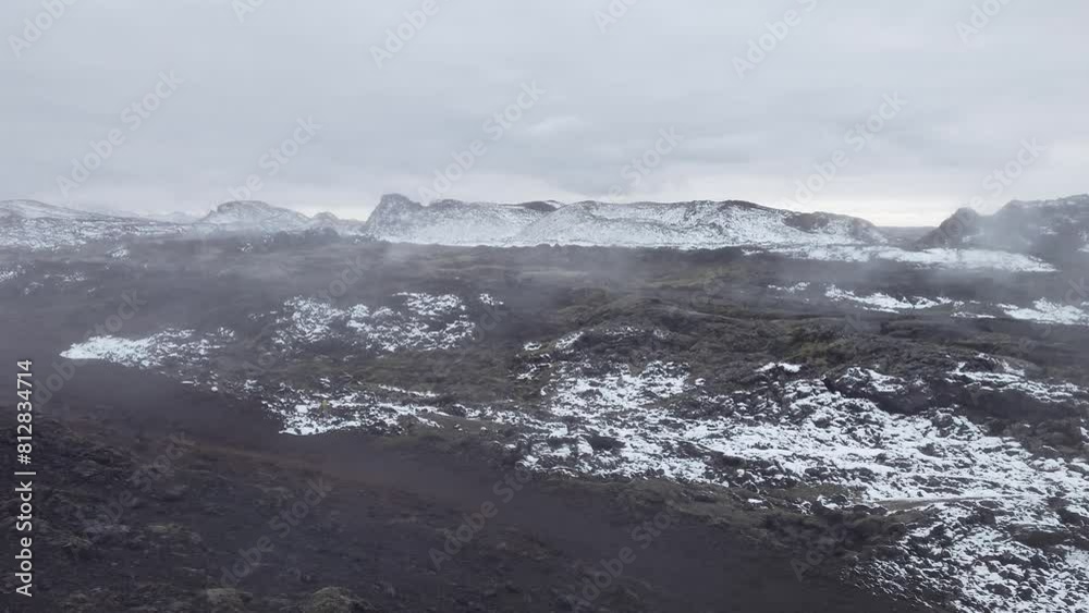 Completely snow-covered Krafla lava fields with areas with water vapor and sulfur geysers. The Leirhnjukur geothermal area in autumn in Iceland. Completely snow-covered Krafla lava fields with areas with water vapor and sulfur geysers. The Leirhnjukur geothermal area in autumn in Iceland.