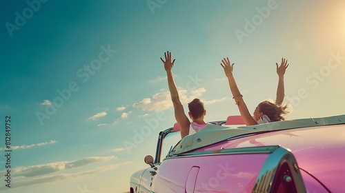 Freedom  happy free couple in car driving in pink vintage retro car cheering joyful with arms raised Friends going on road trip travel on summer day under sun blue sky : Generative AI © Generative AI