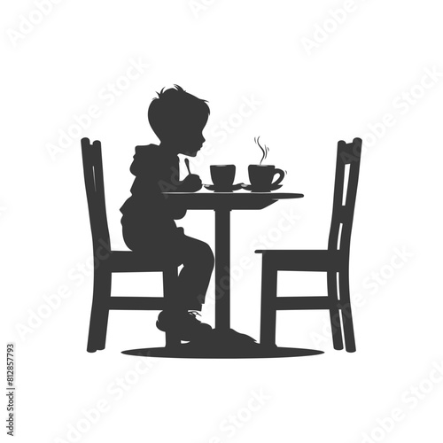 Silhouette little boy sitting at a table in the cafe black color only