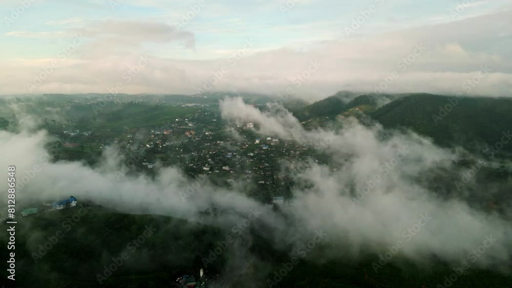 Drone flight over Nuwara Eliya at sunrise, misty mountains, awakening town. Early morning hues bathe landscapes. Sunlight glimmers over tranquil highlands, aerial journey through Sri Lanka beauty. Drone flight over Nuwara Eliya at sunrise, misty mountains, awakening town. Early morning hues bathe landscapes. Sunlight glimmers over tranquil highlands, aerial journey through Sri Lanka beauty.