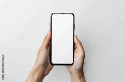 Close up of woman hand holding modern smart phone mockup New modern black frameless smartphone mockup with blank white screen Isolated on white background high quality studio shot