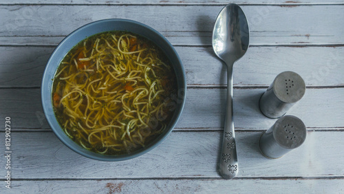 Broth with noodles, salt and pepper