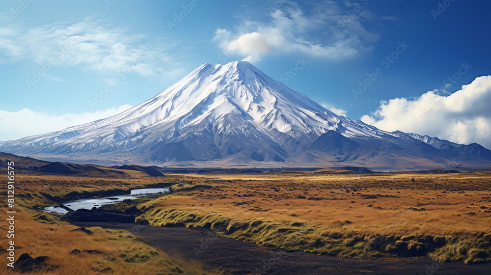 Volcano in a dormant state, with a snowcapped peak and surrounding rugged terrain, under a clear blue sky with a few fluffy clouds Volcano in a dormant state, with a snowcapped peak and surrounding rugged terrain, under a clear blue sky with a few fluffy clouds