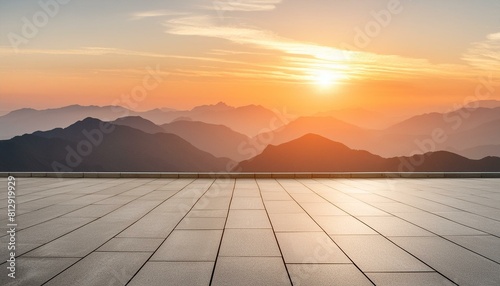 A wide flat roof top with a background of sunset and mountains