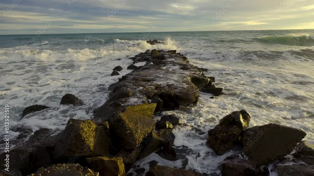 Province of Castellon. Favorite place for active walks. Fishermen fishing on the rocks by the sea. Sun glare on azure sea water. VIA VERDE BENICASIM OROPESA. Mirador dels Banks. Spain Province of Castellon. Favorite place for active walks. Fishermen fishing on the rocks by the sea. Sun glare on azure sea water. VIA VERDE BENICASIM OROPESA. Mirador dels Banks. Spain