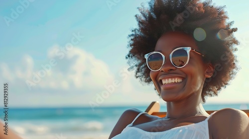 Happy african american woman in sunglasses sitting in deckchair smiling on sunny beach by sea Summer relaxation free time and vacation unaltered : Generative AI #812929355