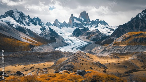 A breathtaking view of a glacier carving its way through a rugged mountain landscape photo