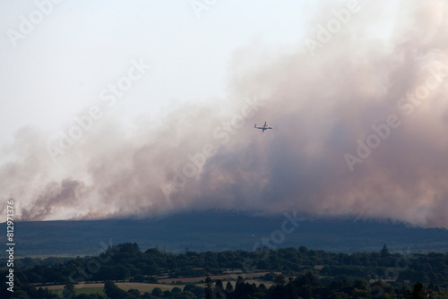 Bombardier Q400 water bomber in action over the fire in the Monts d Arr  e