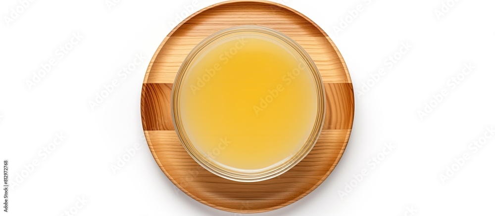 Top view of pure ghee in a wooden bowl alongside cooking oil isolated on a white background with copy space image Top view of pure ghee in a wooden bowl alongside cooking oil isolated on a white background with copy space image