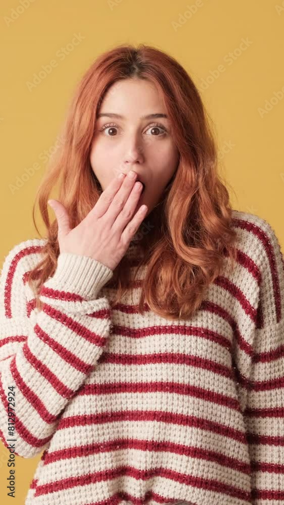 Surprised girl looks to side in studio on yellow background Surprised girl looks to side in studio on yellow background
