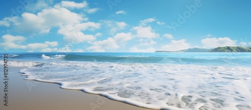 Fototapeta Naklejka Na Ścianę i Meble -  During a sunny summer morning calm blue waves splash on the seashore and beach under a clear sky creating a scenic copy space image