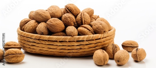 There is a copy space image featuring a white background with an oval wicker basket containing organic walnuts