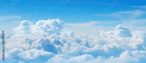 Fototapeta Naklejka Na Ścianę i Meble -  Copy space image of fluffy clouds set against a serene backdrop of a pale blue sky