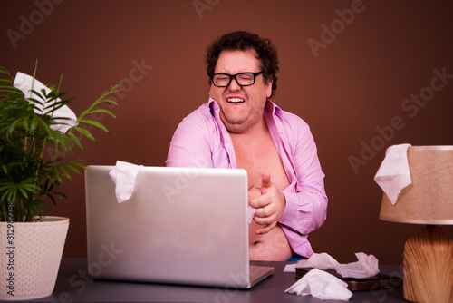 Funny man watches adult films on a laptop at home. photo