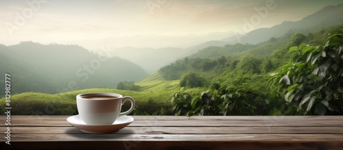 A cup of tea is placed on a rustic wooden table providing ample empty space around it for a picturesque background