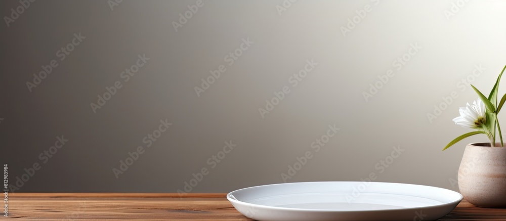 A white plate sits on top of a wooden table with a grey finish creating a serene and modern copy space image A white plate sits on top of a wooden table with a grey finish creating a serene and modern copy space image
