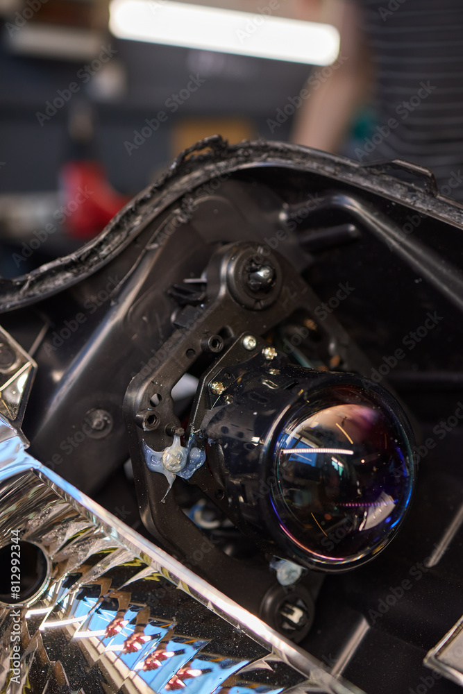 Fototapeta premium Person fixing Automotive lighting with screwdriver on Motor vehicle headlight