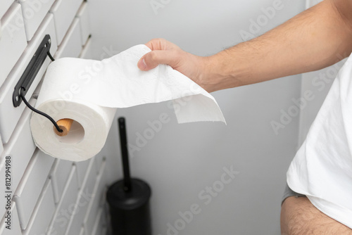 Close-up of Hand using a toilet paper. Hygiene and self care concept	