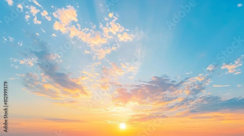 Sunset sky with orange yellow light clouds. Colorful smooth blue sky gradient. Natural background of sunrise. Amazing heaven at morning. Slightly cloudy evening atmosphere. Wonderful weather on dawn. © Anastasija