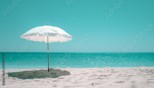 Beach concept. Summer landscape with white umbrella on white sand close to calm sea with sunny blue sky. Minimal. Tropical.
