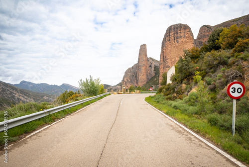 a paved road entering Las Penas de Riglos village  comarca of Hoya de Huesca  province of Huesca  Aragon  Spain