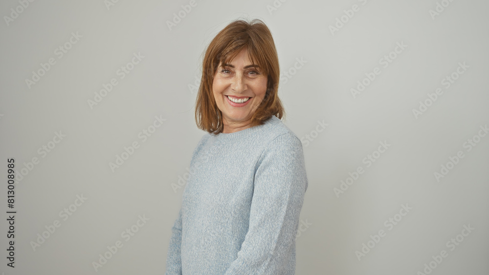 Portrait of a smiling middle-aged woman with short hair in a casual sweater, against a white background. Portrait of a smiling middle-aged woman with short hair in a casual sweater, against a white background.