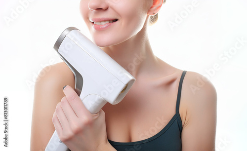 home modern laser epilator in a woman's hand. Hair Remover offering Permanently Smooth Skin. Flash Epilator Laser on a pink background. Female blog concept. Photoepilator for home use. 