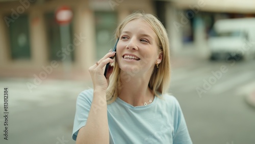 Young blonde woman smiling confident talking on the smartphone at street © Krakenimages.com