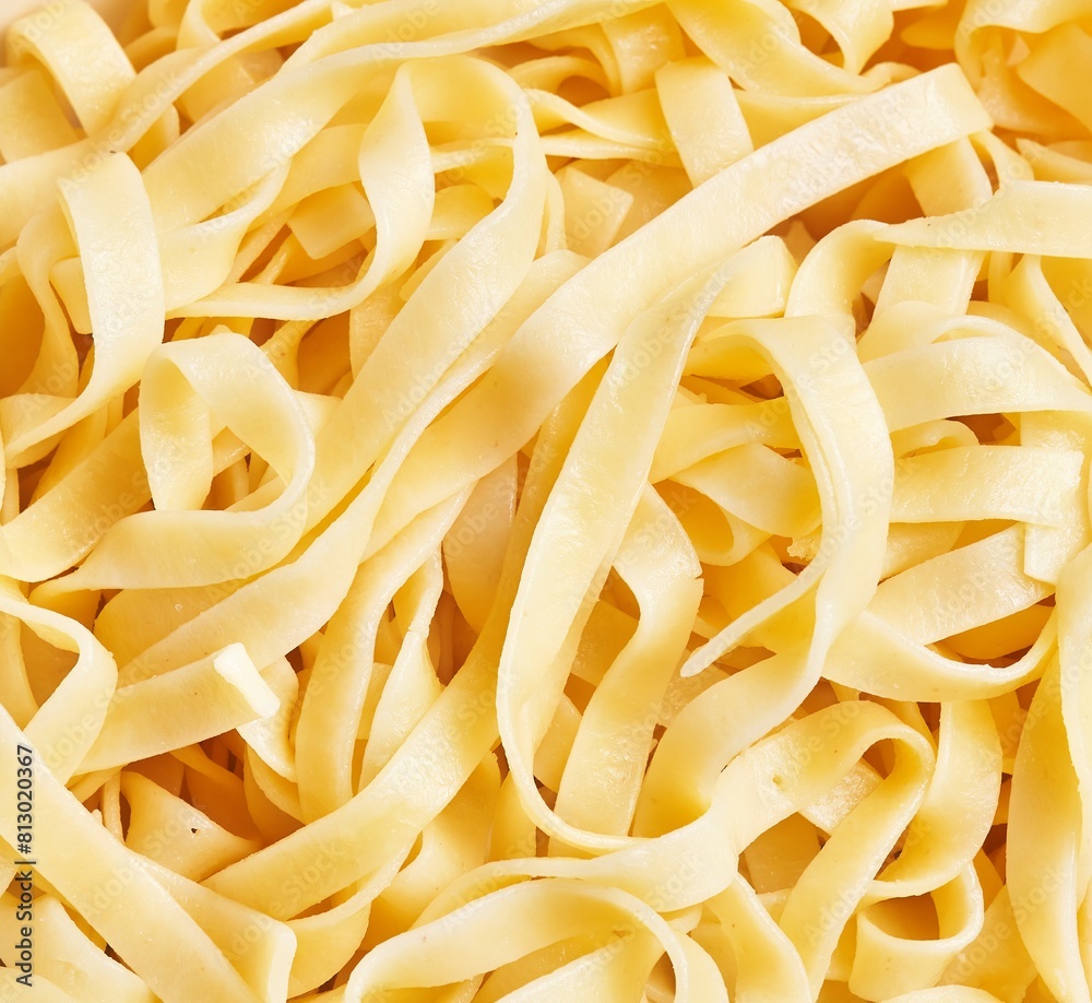 Close-up of fresh fettuccine pasta noodles texture for italian cooking