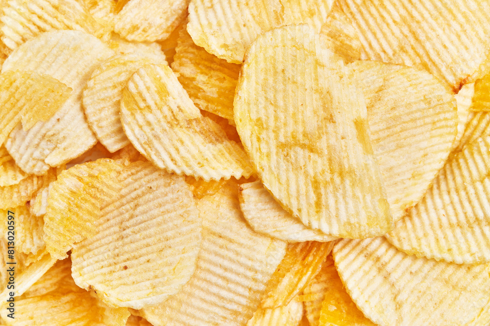 Close-up of crisp, golden potato chips filling the frame, perfect for snacking themes Close-up of crisp, golden potato chips filling the frame, perfect for snacking themes
