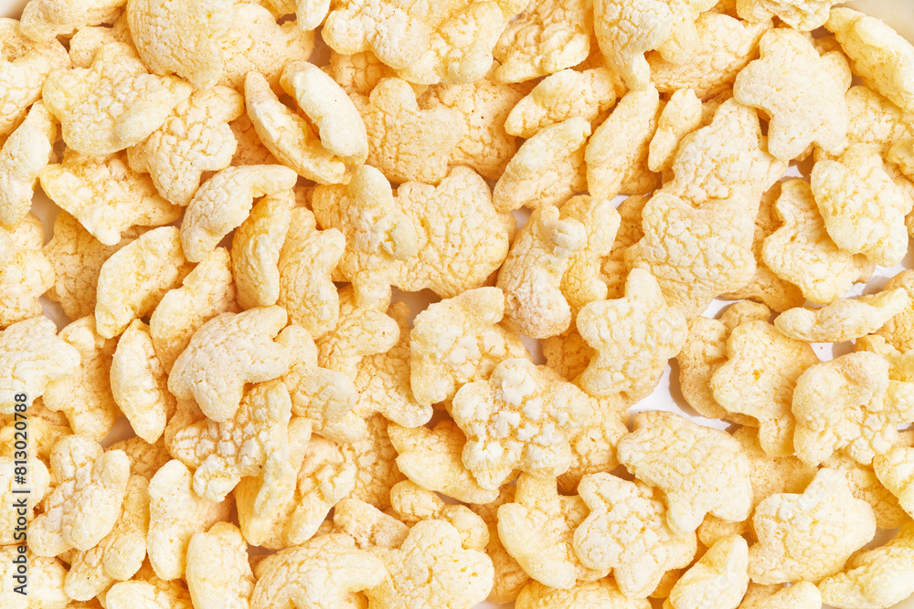 Close-up of yellow rice crackers against a white background with ample texture. Close-up of yellow rice crackers against a white background with ample texture.