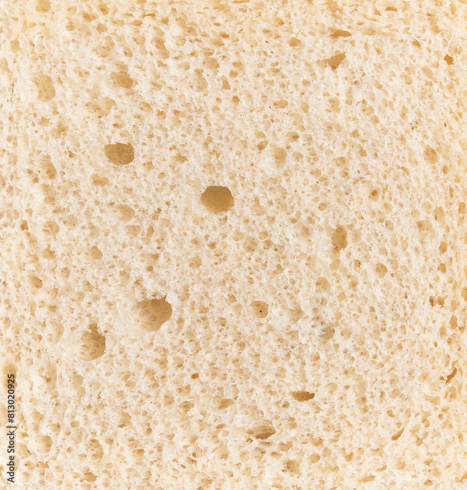 Close-up texture of white bread showing detailed porous structure suitable for food and baking concepts.