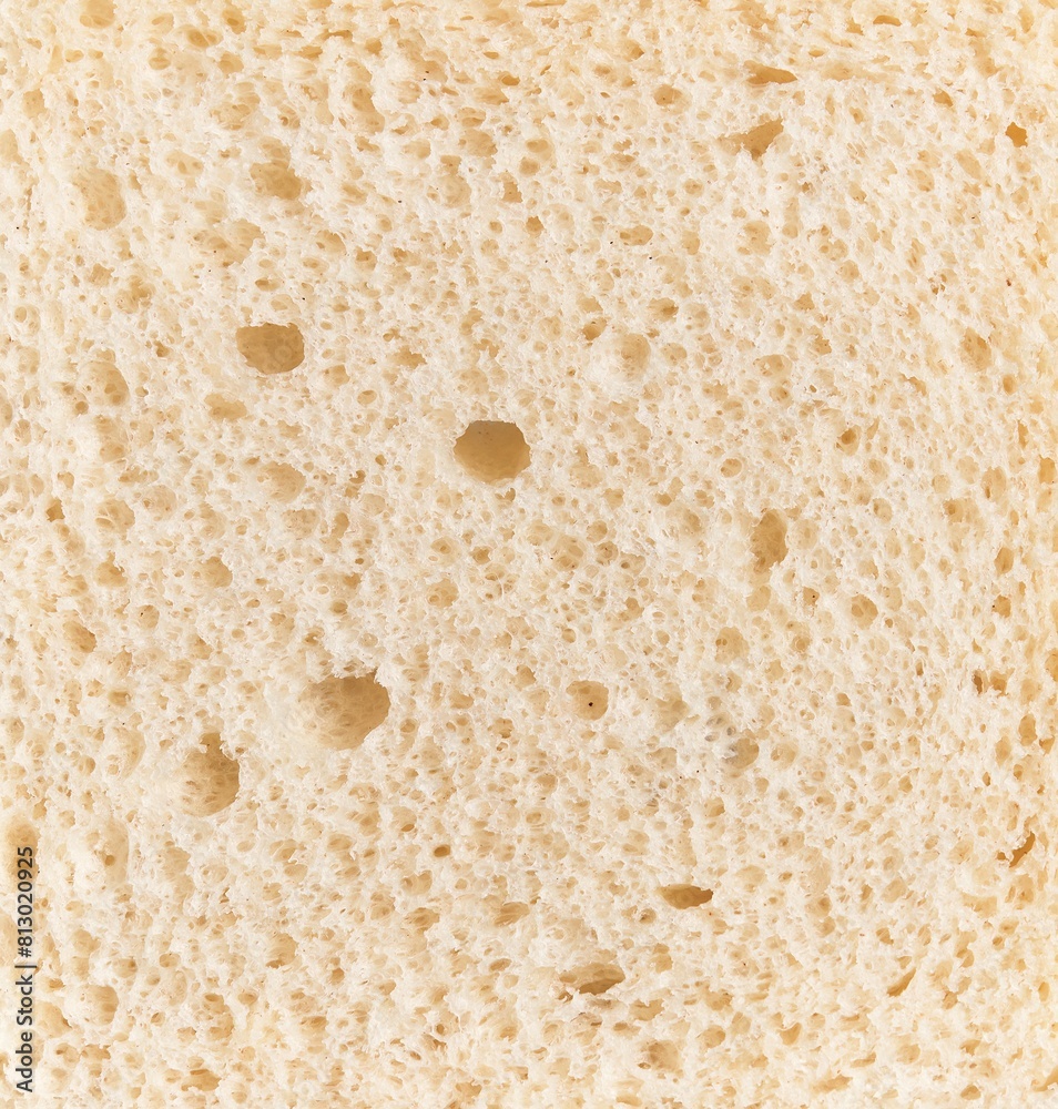 Close-up texture of white bread showing detailed porous structure suitable for food and baking concepts. Close-up texture of white bread showing detailed porous structure suitable for food and baking concepts.
