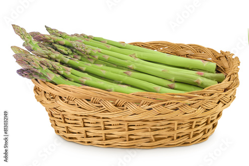 fresh asparagus in in a wicker basket isolated on white background