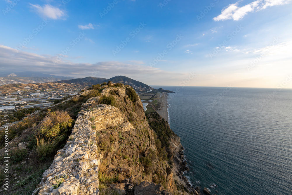 view from the ruins of the old town to the village near the sea, mountain and seascape