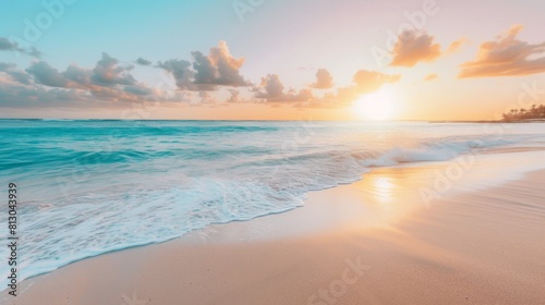 Peaceful beach scene with the sun setting on the horizon, casting a warm glow over the sand and water