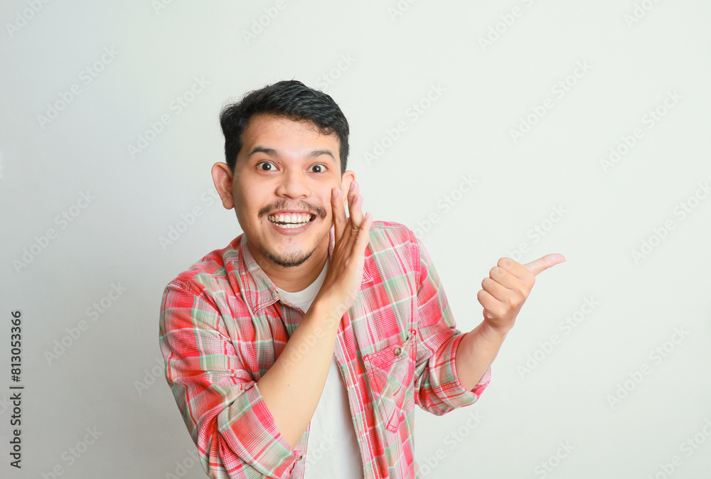 Funny Asian man is whispering some secret gossip isolated on white background. Funny Asian man is whispering some secret gossip isolated on white background.