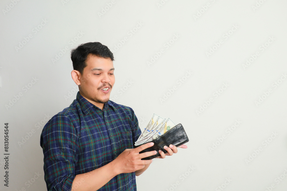 Asian man happy smile show earn money in his hand isolated Asian man happy smile show earn money in his hand isolated
