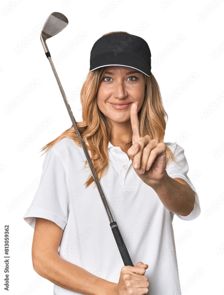 Young blonde golfer in studio showing number one with finger. Young blonde golfer in studio showing number one with finger.