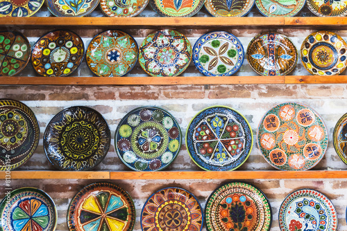 An assortment of handmade Uzbek plates with colorful traditional patterns