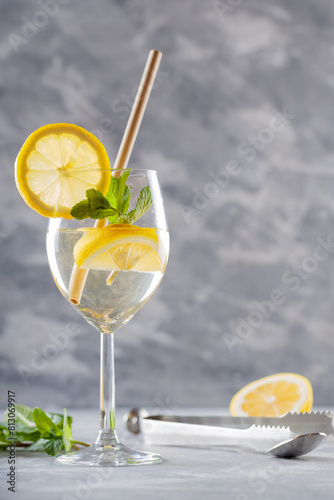 Trendy Elderflower Hugo Spritz Cocktail and Bar Accessories on Gray Concrete Background