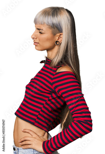 Young caucasian young woman in studio suffering a back pain.