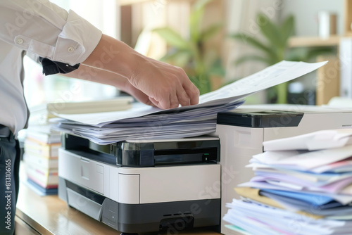 A person is using a printer to print out papers photo