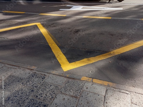 Yellow road markings. Applying yellow lines on the asphalt surface. Zone for the movement of city transport.