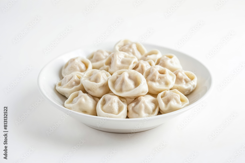bowl of dumplings on a white surface